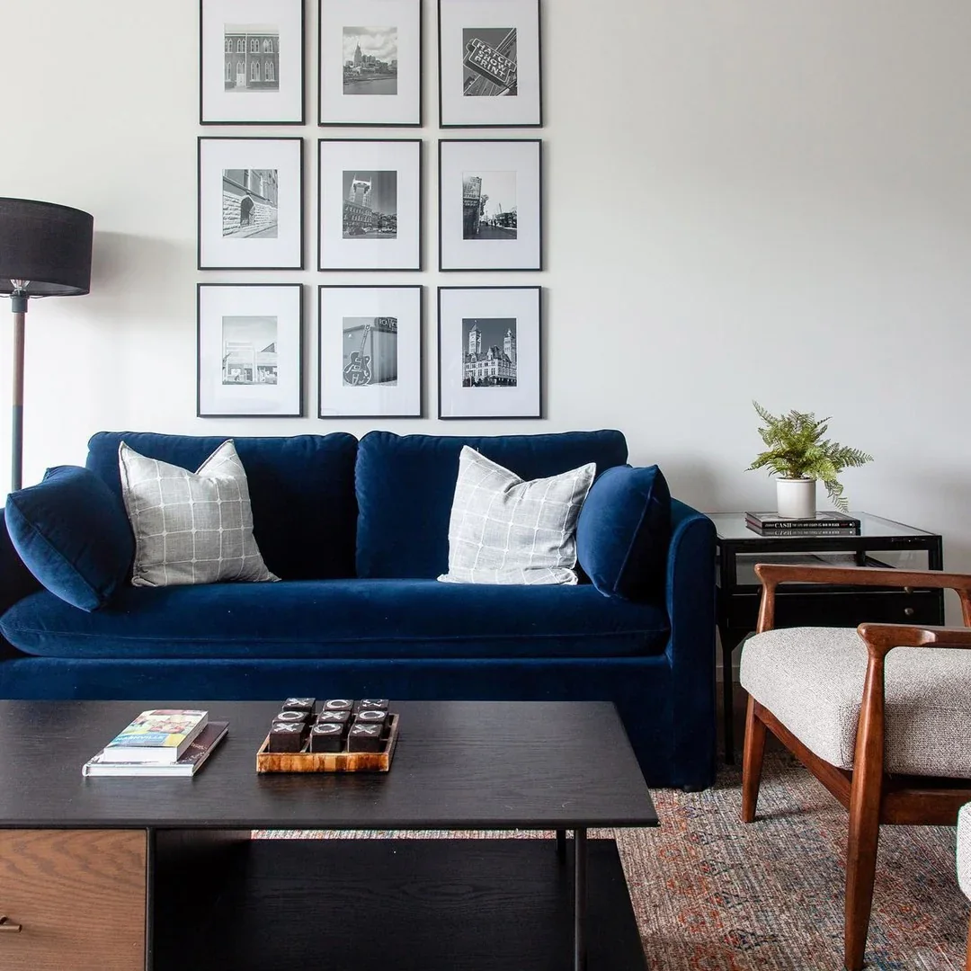 13. Modern Contrast with Navy Sofa and Monochrome Art (Gray and Blue Living Room Ideas)