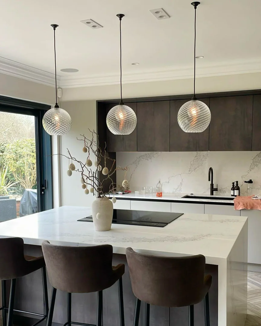 3. Modern Contrast with Marble Layers (Kitchen Lighting Ideas)