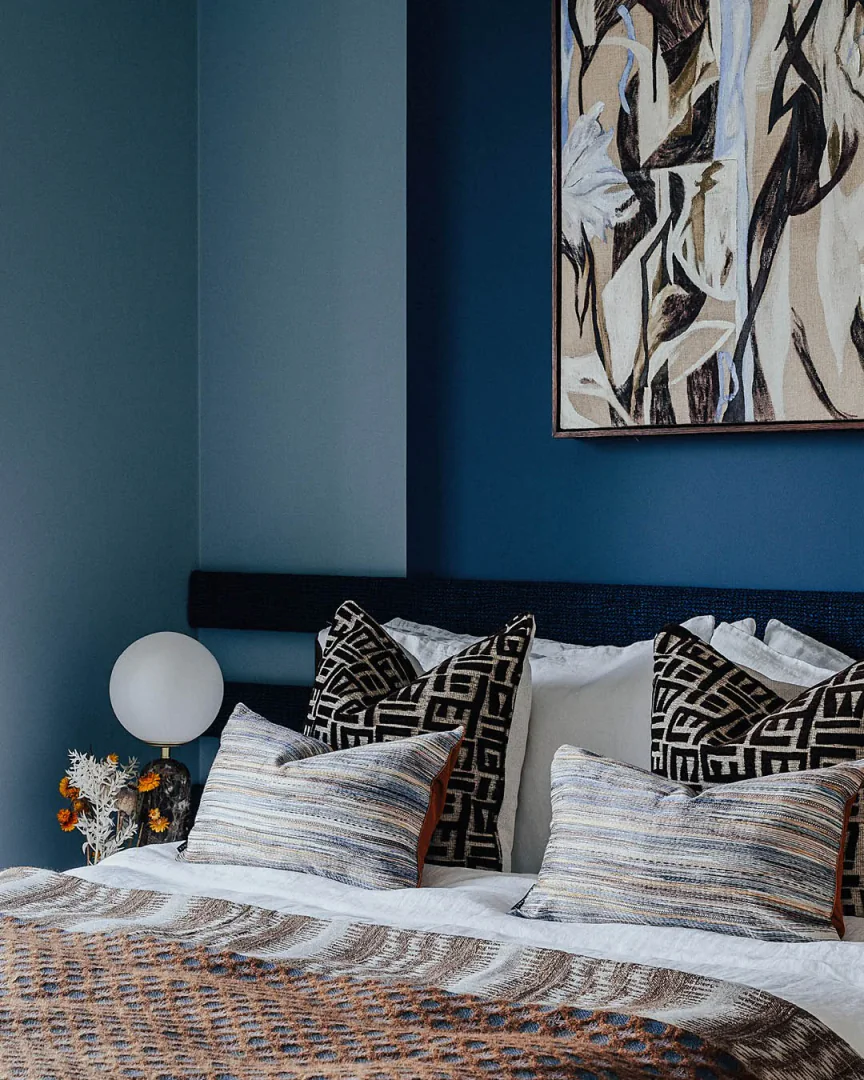 3. Textured Patterns with Deep Blue Walls (Blue Wall Bedroom Ideas)