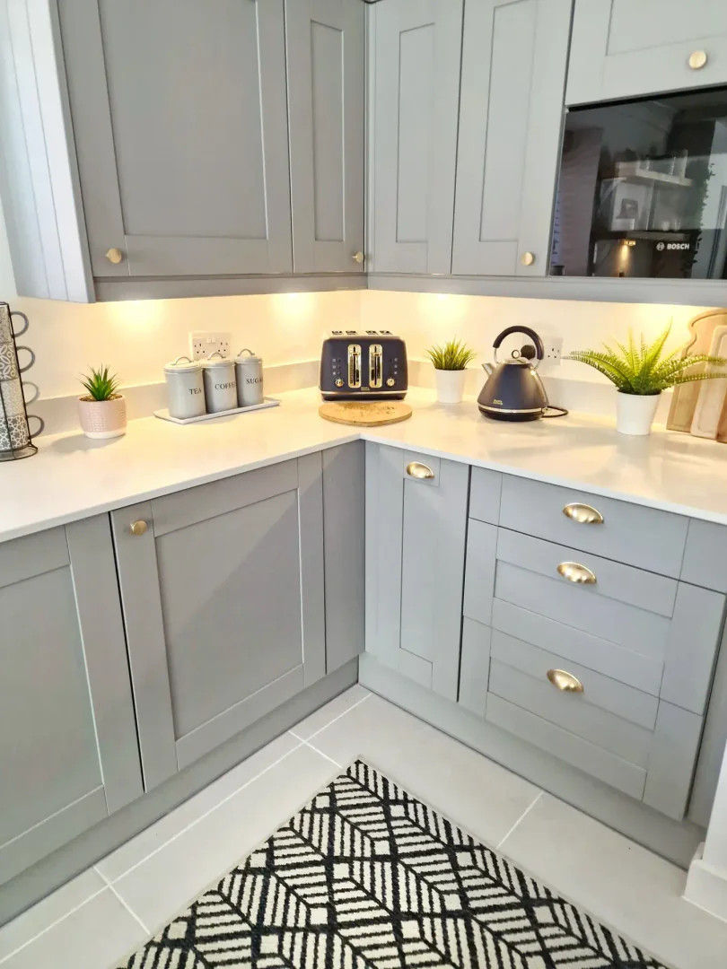 9. Soft Gray-White Contrast with Gold Accents (Small White Kitchen Ideas)