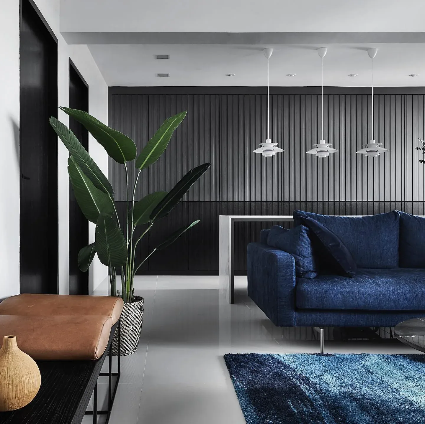 2. Sophisticated Minimalism with Deep Blue Sofa (Grey and Blue Living Room Ideas)