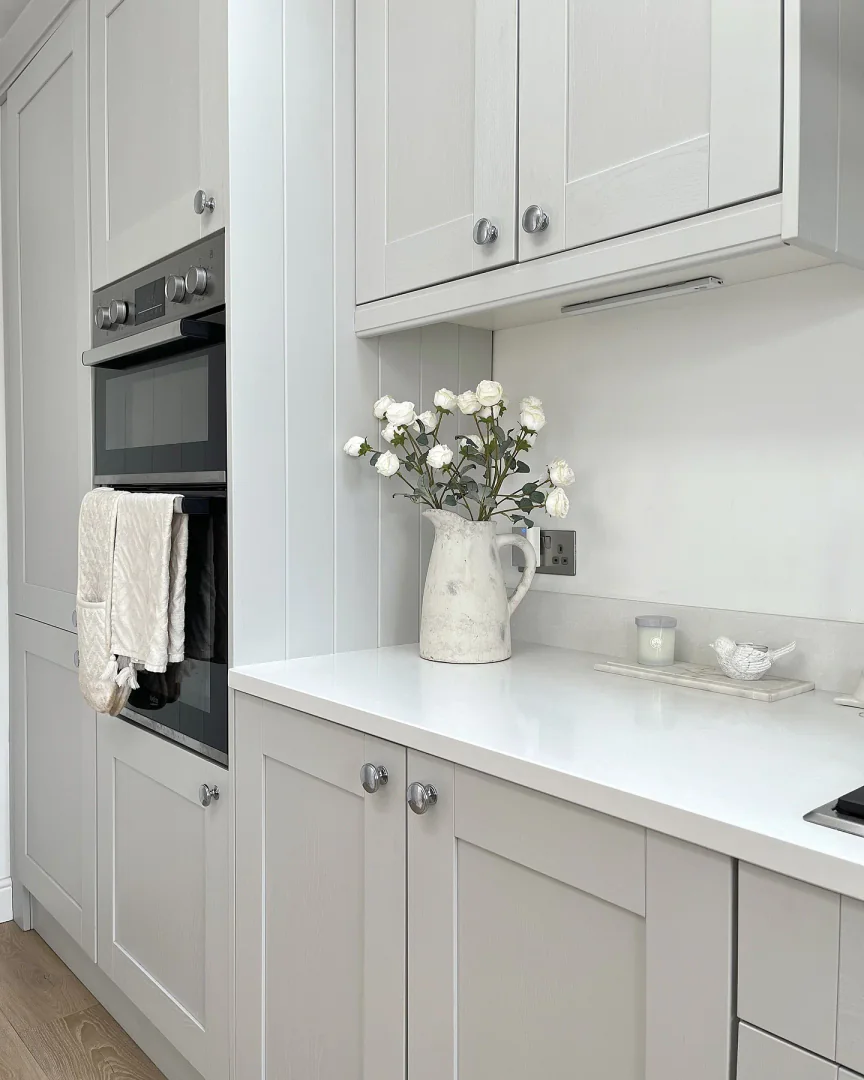 3. Bright Compact Design with Timeless Details (Light Gray Kitchen Ideas)