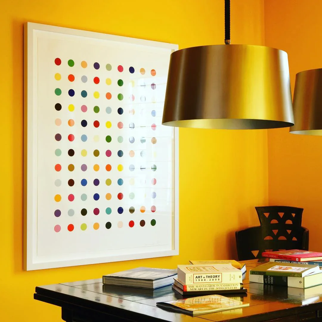 4. Playful Accent Wall with Artistic Touch (Yellow Office Ideas)