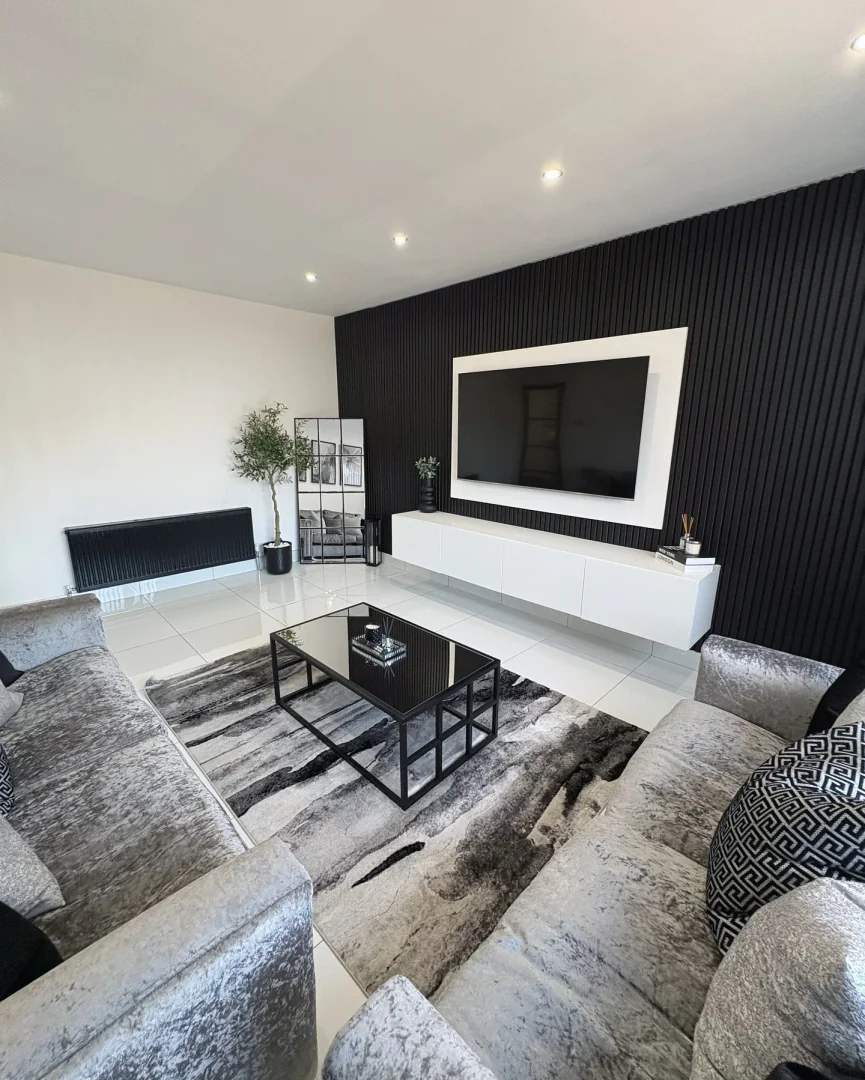 4. Sleek Monochrome with Textural Luxury (Living Room Carpet Ideas)