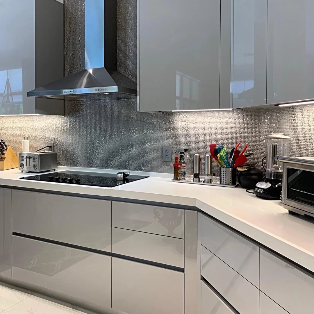 5. High Gloss Modernity with Subtle Sparkle (Light Gray Kitchen Ideas)