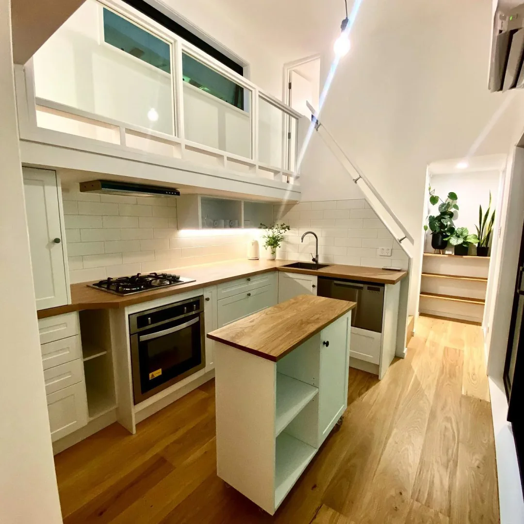 7. Compact White Kitchen with Mobile Island (Tiny House Kitchen Ideas)